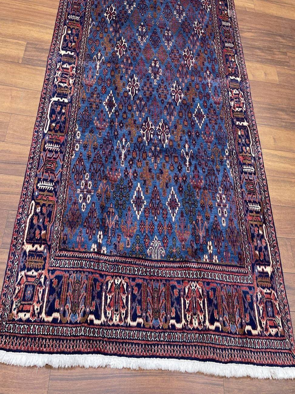 Handmade Bakhtiari carpet with blue field and all-over floral lattice pattern, 294 × 220 cm